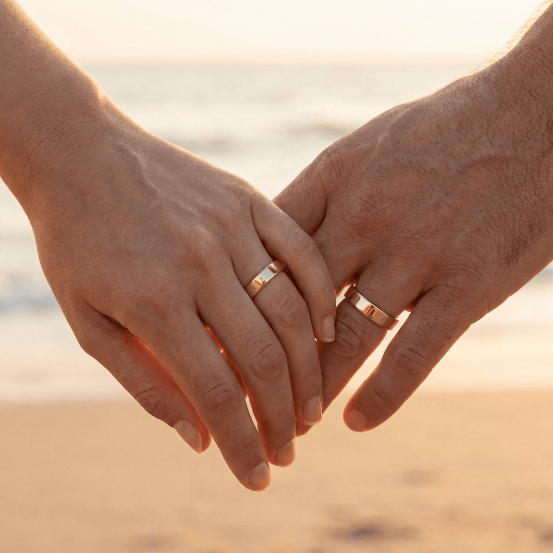 Hands wearing handmade cremation ash rings, memorial jewellery for families