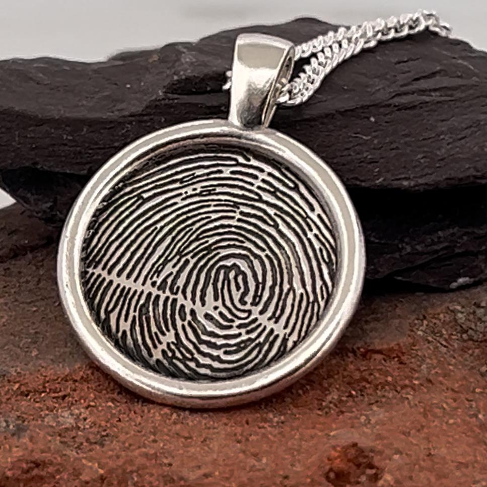 fingerprint necklace, a print engraved onto a round 20mm pendant with bail. Complete with chain. Handmade in the uk in all the precious metals, shown here in sterling silver. 